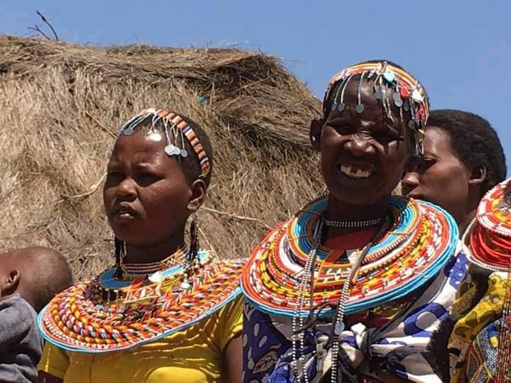 Close portrait of two Maasai women, one an elder, in beaded collars